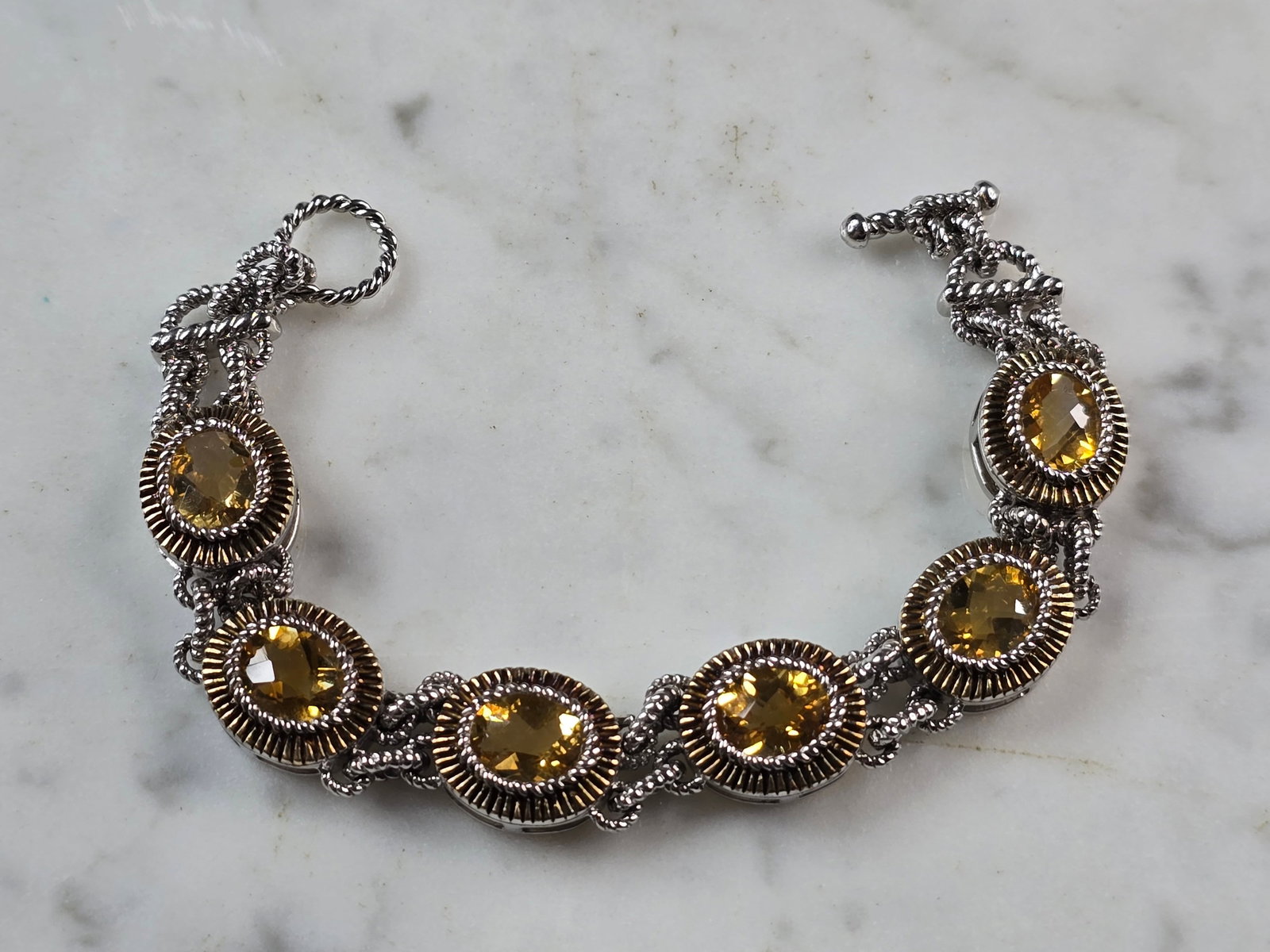 Womens Vintage Estate Sterling Silver Gold Tone Citrine Bracelet: A WOMENS VINTAGE ESTATE STERLING SILVER GOLD TONE BRACELET WITH CITIRINE COLORED STONES. BRACELET IS ABOUT 6 3/4" LONG BY 1/2" WIDE AND WEIGHS 25.3g. NOT SURE IF STONES ARE NATURAL OR MAN MADE. WOULD 