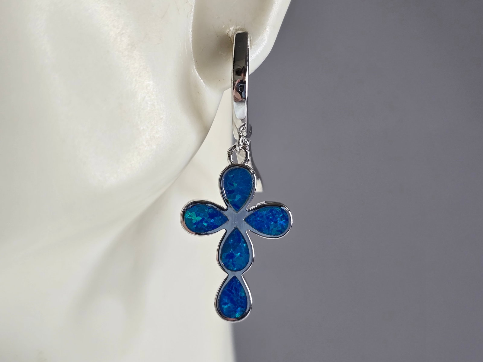 Womens Sterling Silver Blue Opal Cross Earrings: A PAIR OF WOMENS STERLING SILVER BLUE OPAL COLORED CROSS EARRINGS THAT WEIGH 5.6g AND MEASURES 1 1/4" LONG BY 1/2" WIDE. NOT SURE IF STONES ARE NATURAL OR MAN MADE. ANY QUESTIONS, PLEASE DO NOT HESITA