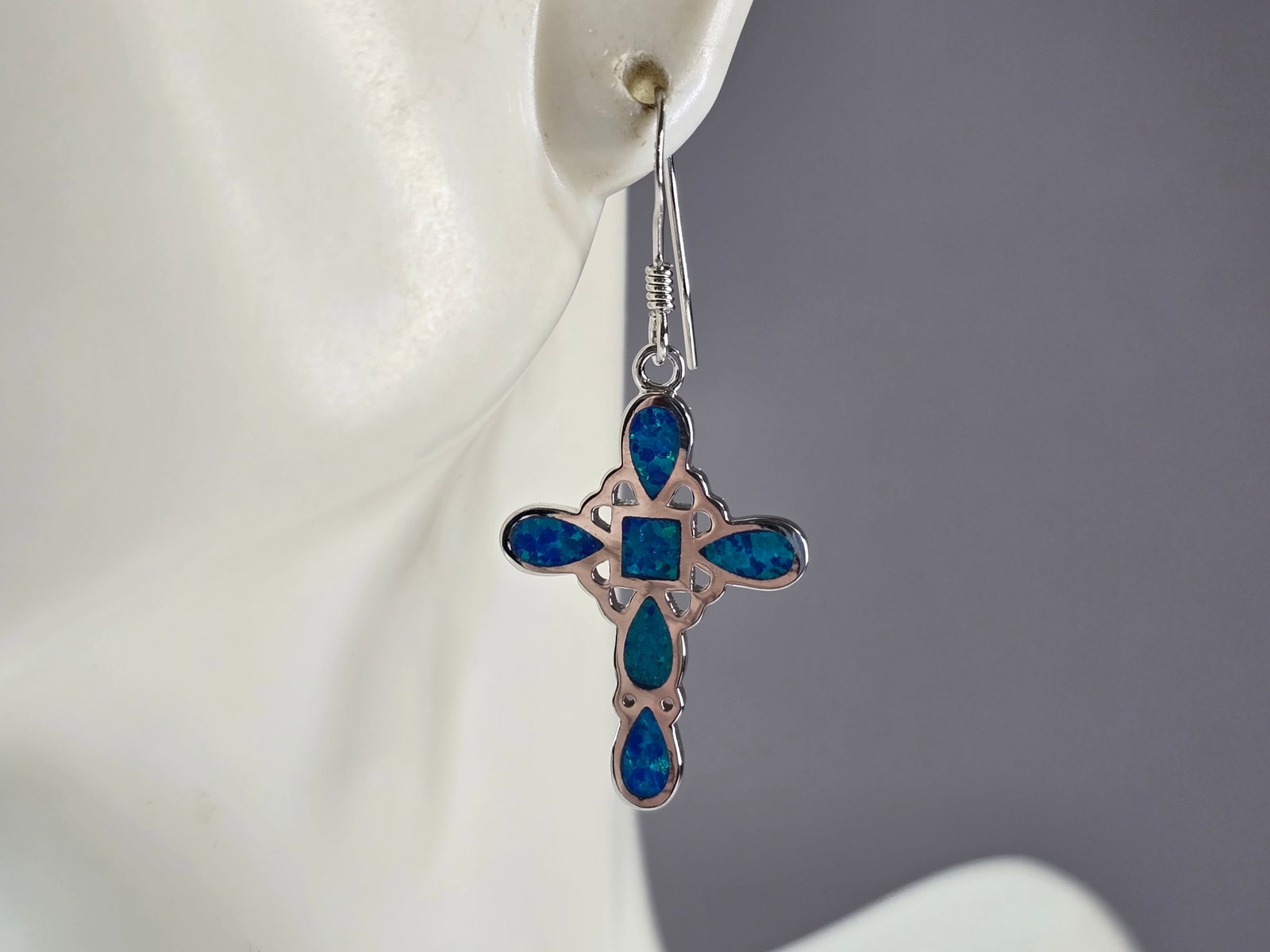 Womens Sterling Silver Blue Opal Cross Earrings: A PAIR OF WOMENS STERLING SILVER BLUE OPAL COLORED CROSS EARRINGS THAT WEIGH 4.2g AND MEASURES 1 1/2" LONG BY 5/8" WIDE. NOT SURE IF STONES ARE NATURAL OR MAN MADE. ANY QUESTIONS, PLEASE DO NOT HESITA