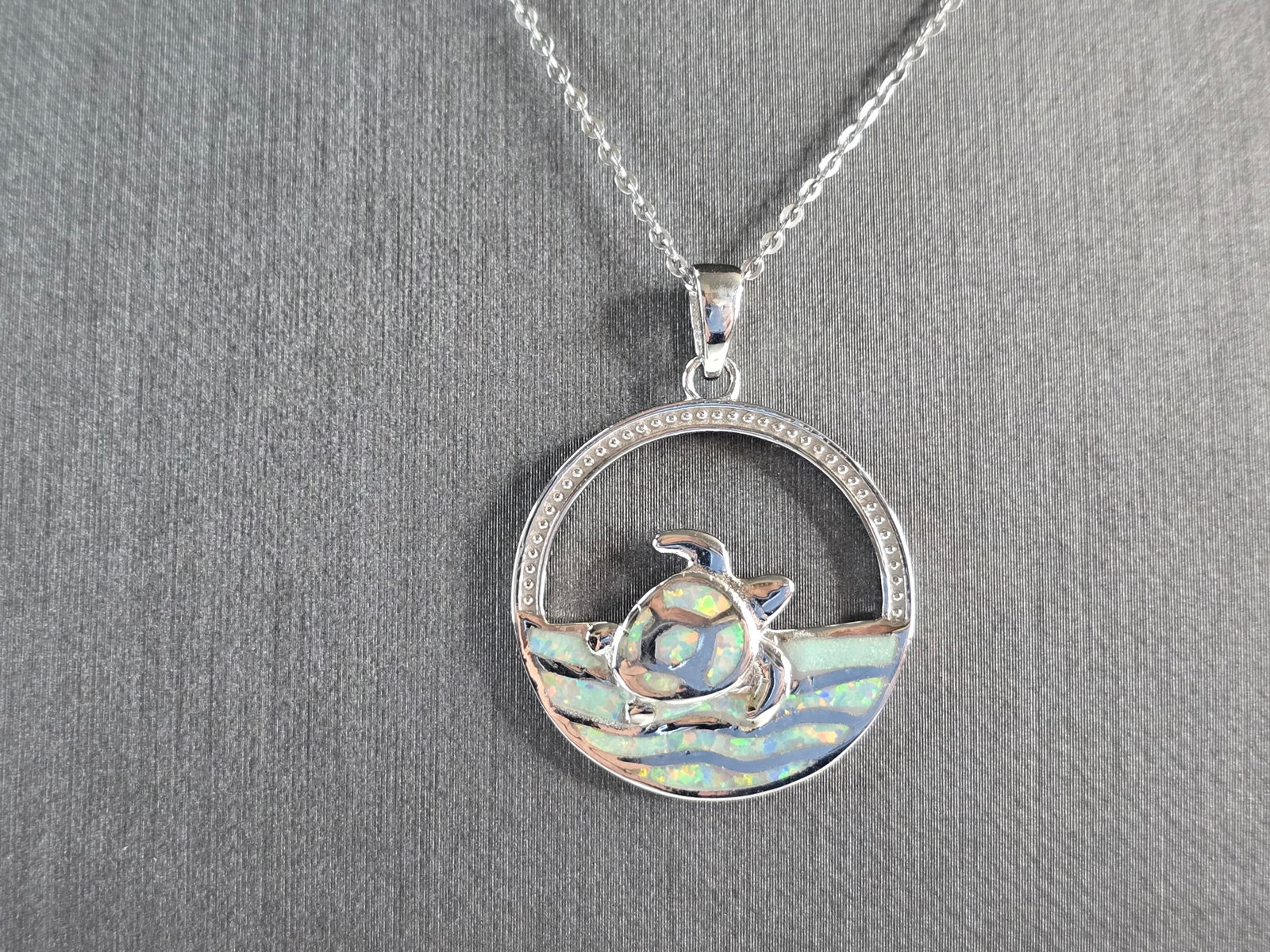 Womens Sterling Silver Sea Turtle Pendant Necklace: A WOMENS STERLING SILVER OPAL SEA TURTLE PENDANT. THE PENDANT WITH NECKLACE WEIGHS 7.3g. THE PENDANT MEASURES 1 1/4" LONG BY 1" WIDE, AND THE NECKLACE MEASURES 18" LONG, ADJUSTABLE TO 16". NOT SURE IF