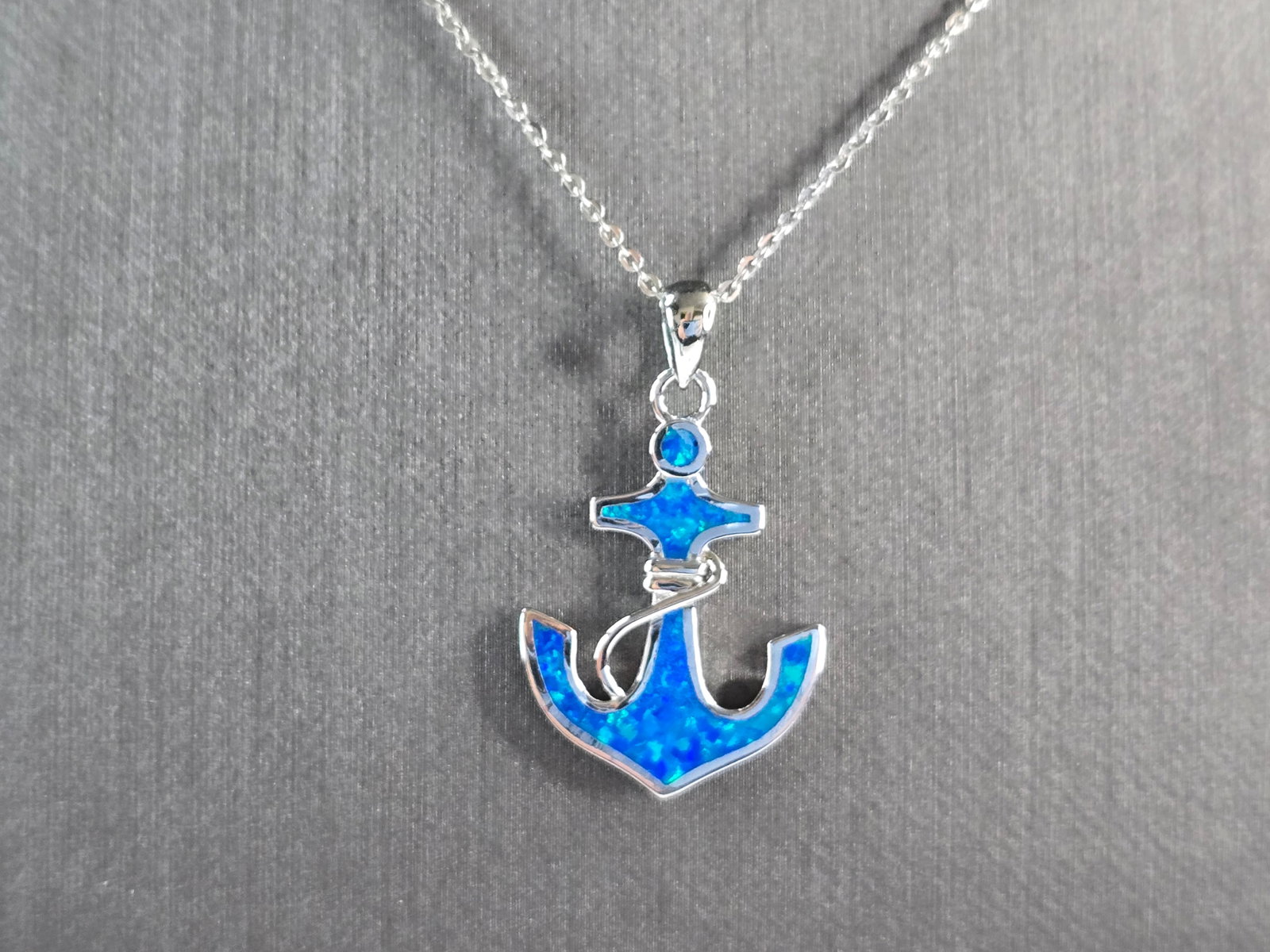 Womens Sterling Silver Blue Opal Maritime Anchor Pendant Necklace: A WOMENS STERLING SILVER OPAL ANCHOR PENDANT WITH NECKLACE. THE PENDANT AND NECKLACE WEIGHS 4.5g. THE PENDANT MEASURES 1 1/4" LONG BY 3/4" WIDE, AND THE NECKLACE MEASURES 18" LONG ADJUSTABLE TO 16". N