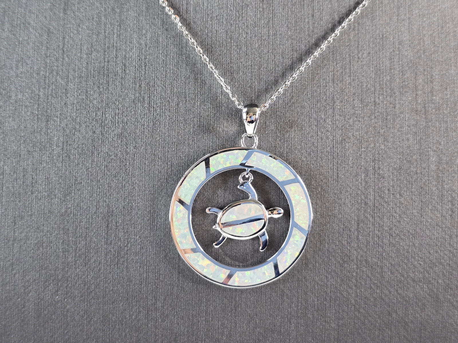 Womens Sterling Silver Opal Sea Turtle Pendant Necklace: A WOMENS STERLING SILVER OPAL SEA TURTLE PENDANT. THE PENDANT WITH NECKLACE WEIGHS 6.2g. THE PENDANT MEASURES 1 3/8" LONG BY 1 1/8" WIDE, AND THE NECKLACE MEASURES 18" LONG, ADJUSTABLE TO 16". NOT SUR