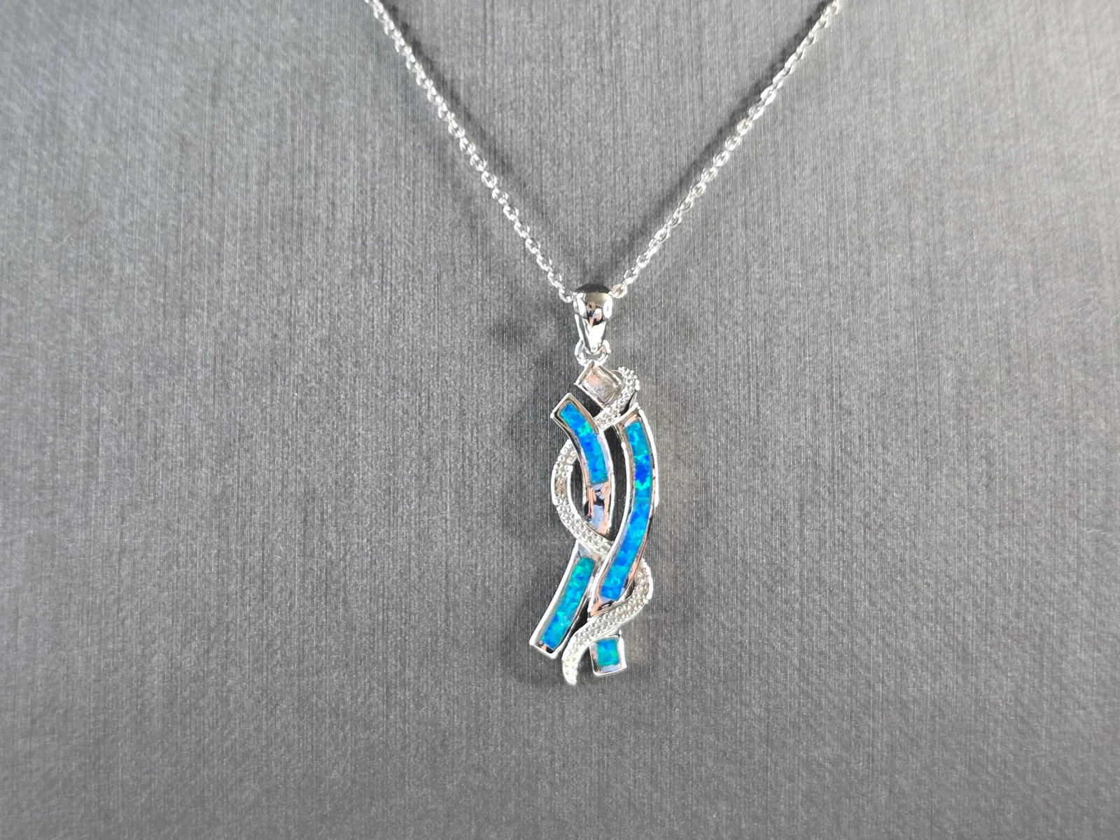 Womens Sterling Silver Blue Opal Modernist Pendant Necklace: A WOMENS STERLING SILVER BLUE OPAL MODERNIST PENDANT. THE PENDANT WITH NECKLACE WEIGHS 5.2g. THE PENDANT MEASURES 1 1/2" LONG BY 3/8" WIDE, AND THE NECKLACE MEASURES 18" LONG, ADJUSTABLE TO 16" LONG. 