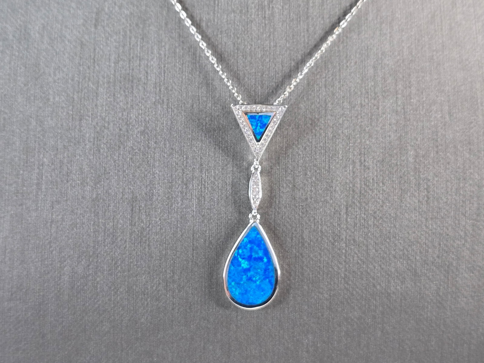 Womens Sterling Silver Blue Opal Modernist Pendant Necklace: A WOMENS STERLING SILVER BLUE OPAL MODERNIST PENDANT. THE PENDANT WITH NECKLACE WEIGHS 5.2g. THE PENDANT MEASURES 1 3/4" LONG BY 1/2" WIDE, AND THE NECKLACE MEASURES 18" LONG, ADJUSTABLE TO 16" LONG. 