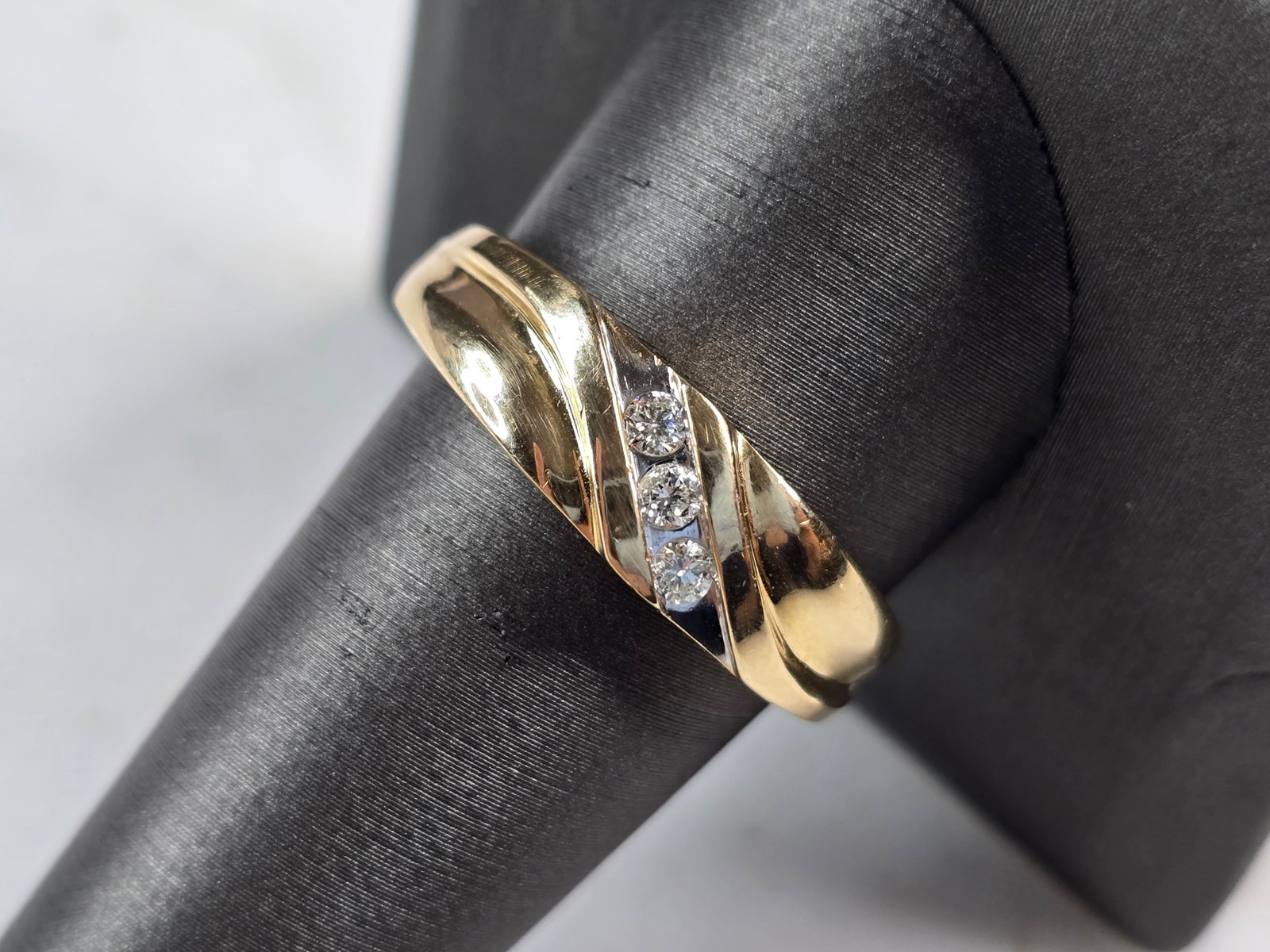 Mens Vintage Estate 10k Yellow Gold Diamond Ring: A MENS VINTAGE ESTATE 10K YELLOW GOLD DIAMOND RING. THE SIZE OF THE RING IS A 10.75, AND WEIGHS 7.2g. THE WIDTH OF THE BAND IS 5/16". RING HAS 3 SMALL DIAMONDS, ABOUT .05cts EACH. RING IS STAMPED 10K.