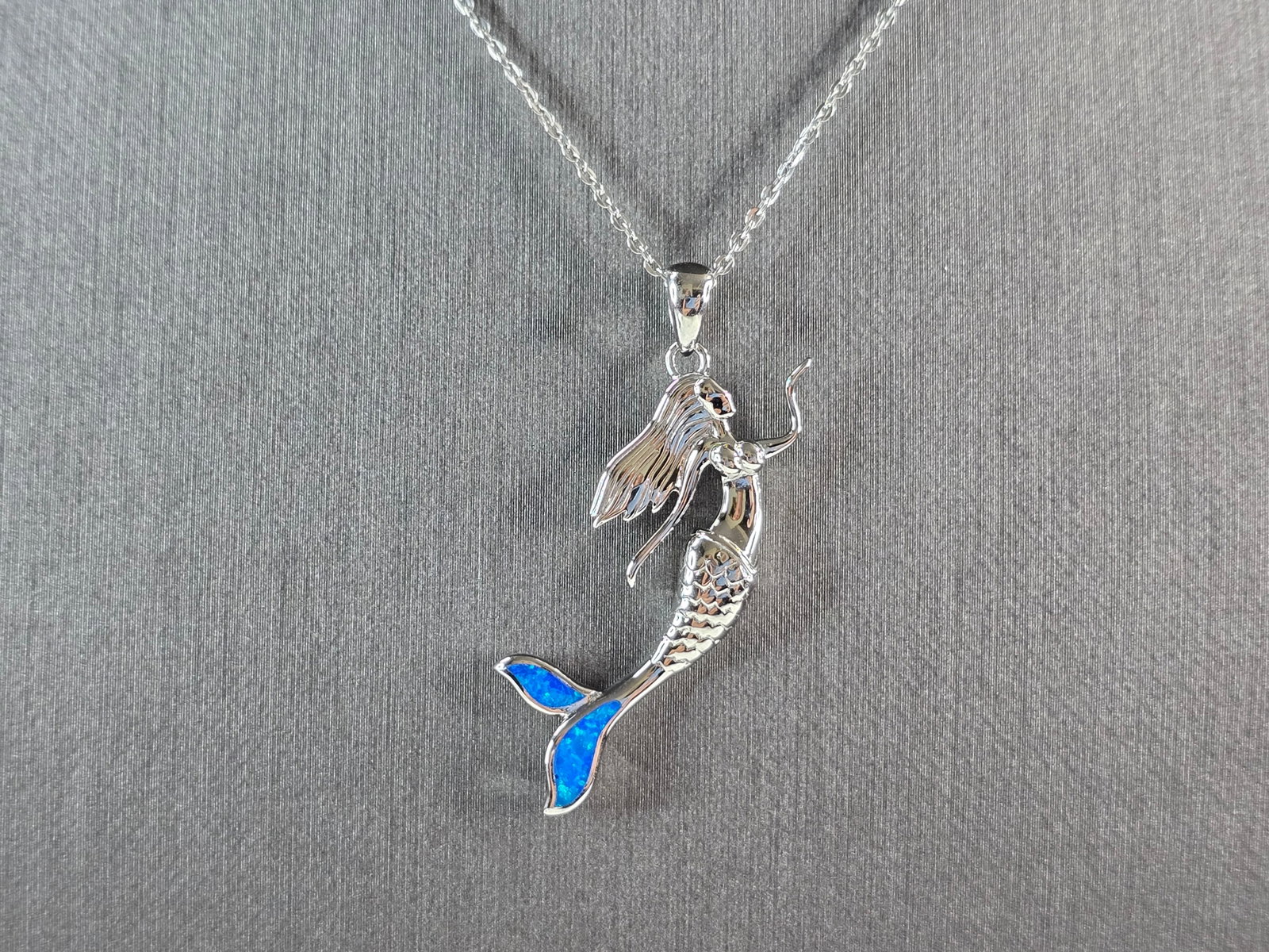 Womens Sterling Silver Blue Opal Mermaid Pendant Necklace: A WOMENS STERLING SILVER BLUE OPAL MERMAID PENDANT WITH NECKLACE. THE PENDANT AND NECKLACE WEIGHS 6.0g. THE PENDANT MEASURES 1 1/2" LONG BY 5/8" WIDE. THE NECKLACE MEASURES 18" LONG AND IS ADJUSTABLE 