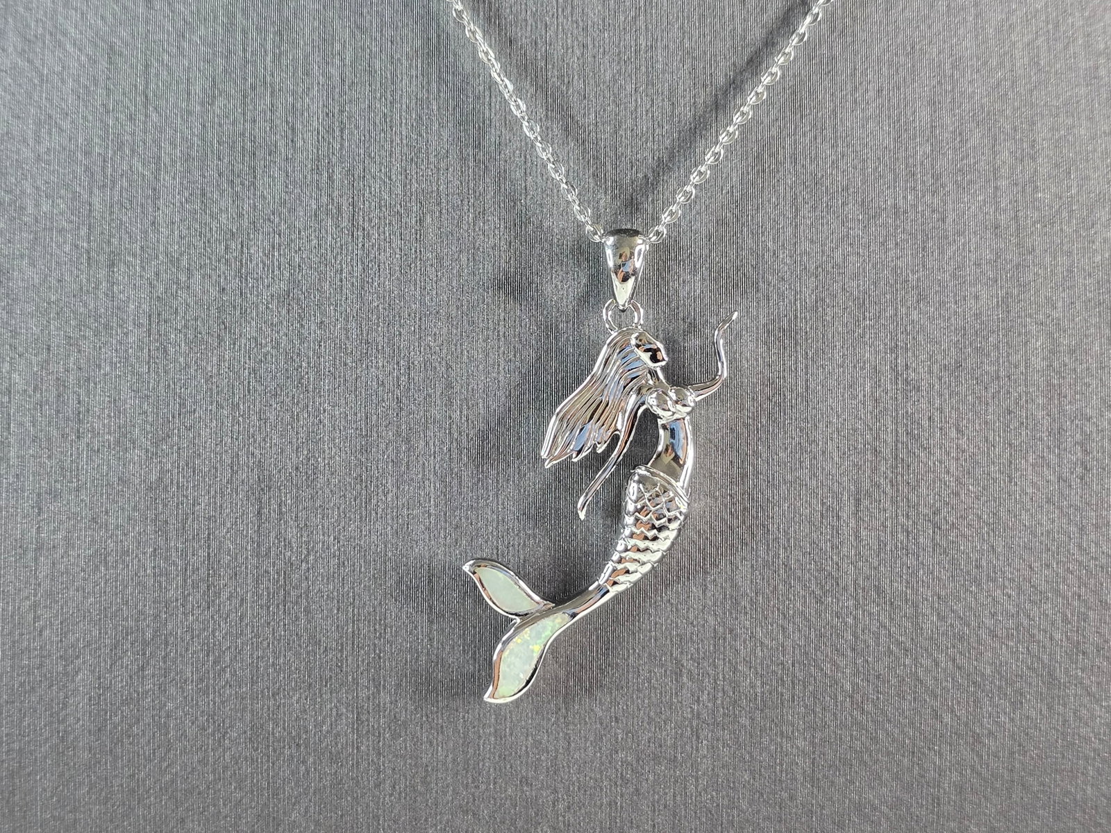 Womens Sterling Silver Opal Mermaid Pendant Necklace: A WOMENS STERLING SILVER OPAL MERMAID PENDANT WITH NECKLACE. THE PENDANT AND NECKLACE WEIGHS 6.0g. THE PENDANT MEASURES 1 1/2" LONG BY 5/8" WIDE. THE NECKLACE MEASURES 18" LONG AND IS ADJUSTABLE TO 16