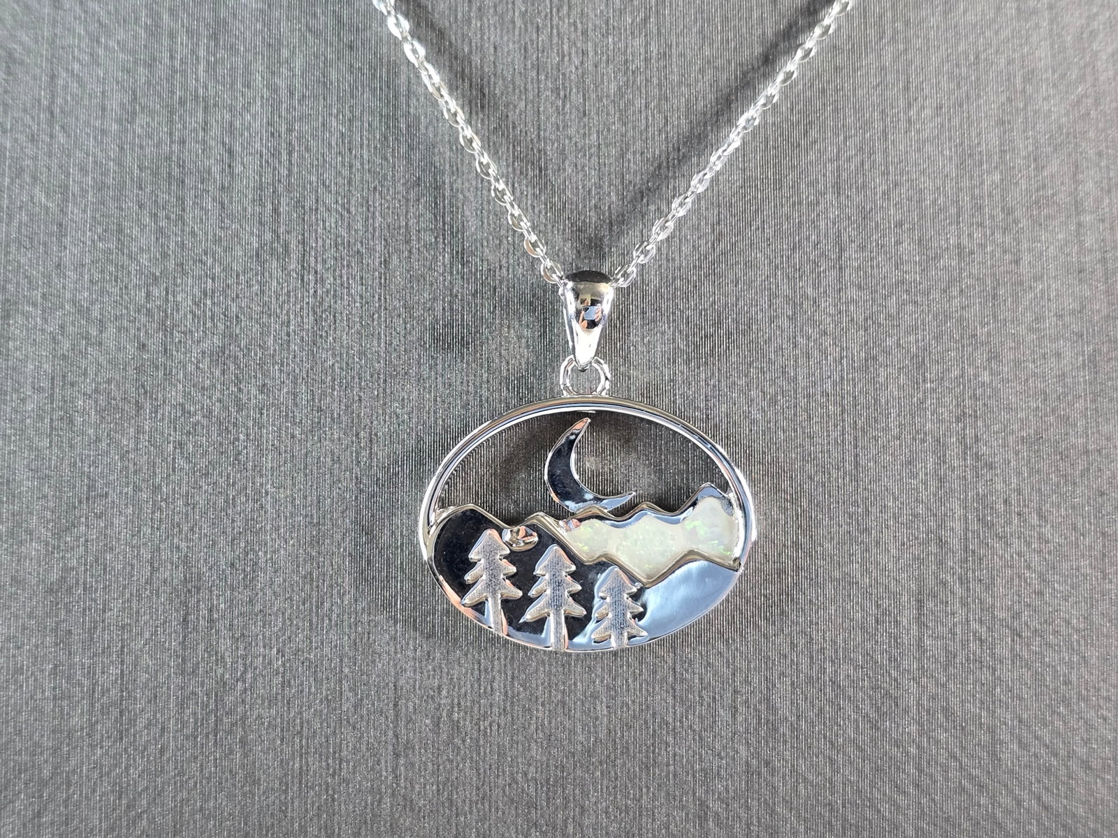 Womens Sterling Silver Opal Mountain Moon Tree Pendant Necklace: A WOMENS STERLING SILVER OPAL MOUNTAIN MOON PENDANT. THE PENDANT WITH NECKLACE WEIGHS 5.4g. THE PENDANT MEASURES 7/8" LONG BY 7/8" WIDE. THE NECKLACE MEASURES 18" LONG AND IS ADJUSTABLE TO 16" LONG. N