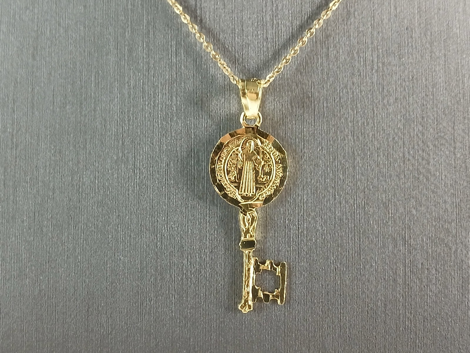Womens Sterling Silver Gold Tone Saint Benedict Key Pendant Necklace: A WOMENS STERLING SILVER GOLD TONE RELGIOUS SAINT BENEDICT KEY PENDANT WITH NECKLACE. THE TOTAL WEIGHT IS 3.1g. THE PENDANT MEASURES 1 1/2" LONG BY 1/2" WIDE, AND THE NECKLACE MEASURES 18" LONG, AND I