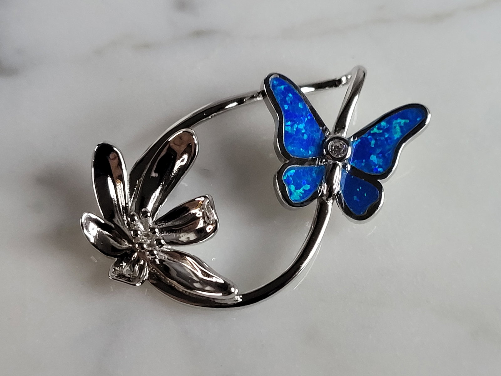 Womens Sterling Silver Blue Opal Butterfly Pendant: A WOMENS STERLING SILVER BLUE OPAL BUTTERFLY PENDANT. NOT SURE IF STONES ARE REAL OR MAN MADE. THE PENDANT WEIGHS 4.1g AND MEASURES 1 1/4" LONG BY 3/4" WIDE. MAKES A GREAT GIFT FOR THAT SOMEONE SPECIA