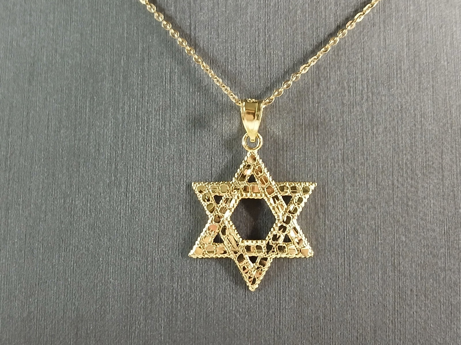 Sterling Silver Gold Tone Jewish Judaica Star of David Pendant: A STERLING SILVER GOLD TONE STAR OF DAVID PENDANT WITH NECKLACE. THE PENDANT WITH NECKLACE WEIGHS 2.7g. THE NECKLACE MEASURES 18" LONG, AND THE PENDANT MEASURES 1 1/8" LONG BY 3/4" WIDE. MAKES A GREAT