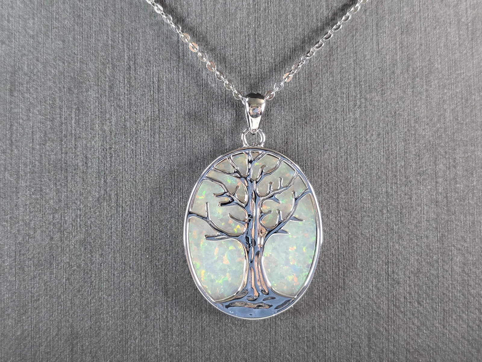 Womens Sterling Silver Opal Tree of Life Pendant Necklace: A WOMENS ESTATE STERLING SILVER OPAL TREE OF LIFE PENDANT WITH NECKLACE. THE PENDANT WITH THE NECKLACE WEIGHS 9.0g. PENDANT MEASURES 1 3/8" LONG BY 7/8" WIDE. THE NECKLACE MEASURES 18" LONG. NOT SURE 