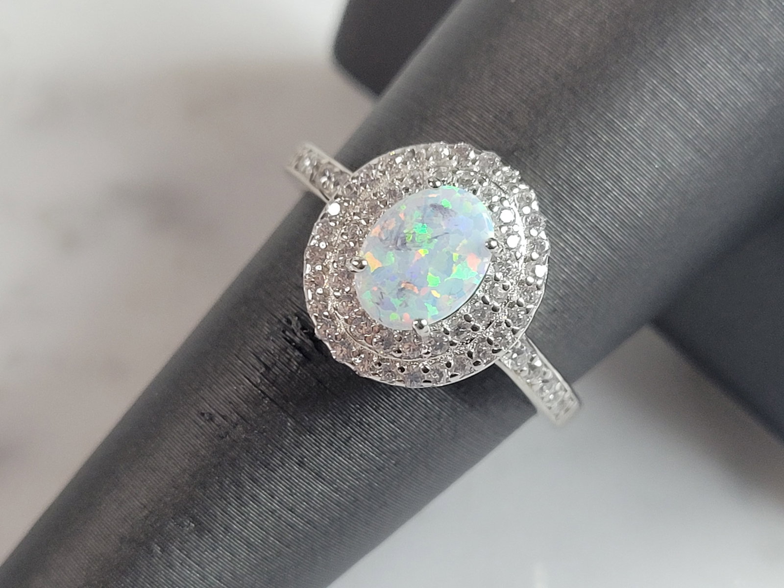 Womens Sterling Silver Modernist Opal Ring: A WOMENS STERLING SILVER MODERNIST OPAL RING. THE RING IS A SIZE 6.5, AND WEIGHS 3.0g. THE WIDTH OF THE RING IS 1/2". THE RING MAKES A BEAUTIFUL GIFT FOR THAT SOMEONE SPECIAL. ANY OTHER QUESTIONS, PLE