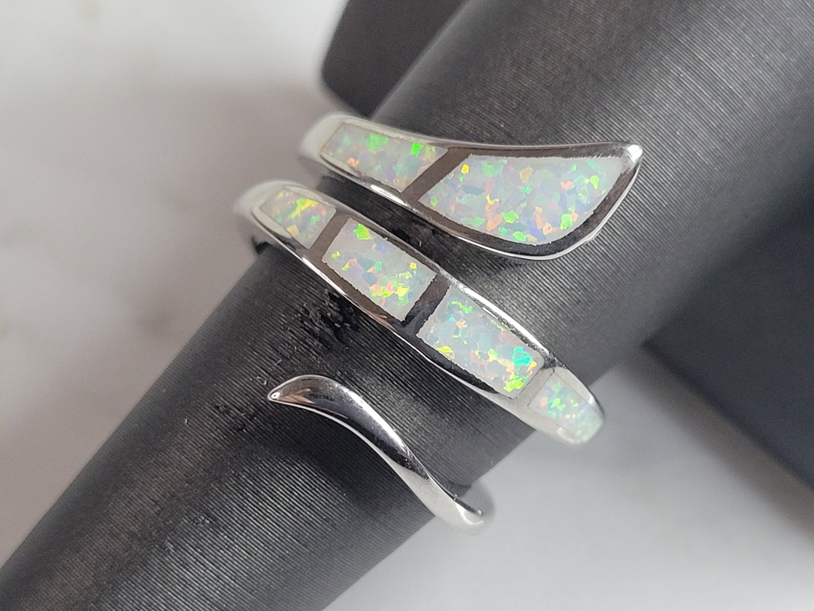 Womens Sterling Silver Modernist Opal Ring: A WOMENS STERLING SILVER MODERNIST OPAL SPIRAL RING. THE RING IS A SIZE 8.0, AND WEIGHS 6.9g. THE WIDTH OF THE RING IS 3/4". THE RING MAKES A BEAUTIFUL GIFT FOR THAT SOMEONE SPECIAL. ANY QUESTIONS, PL