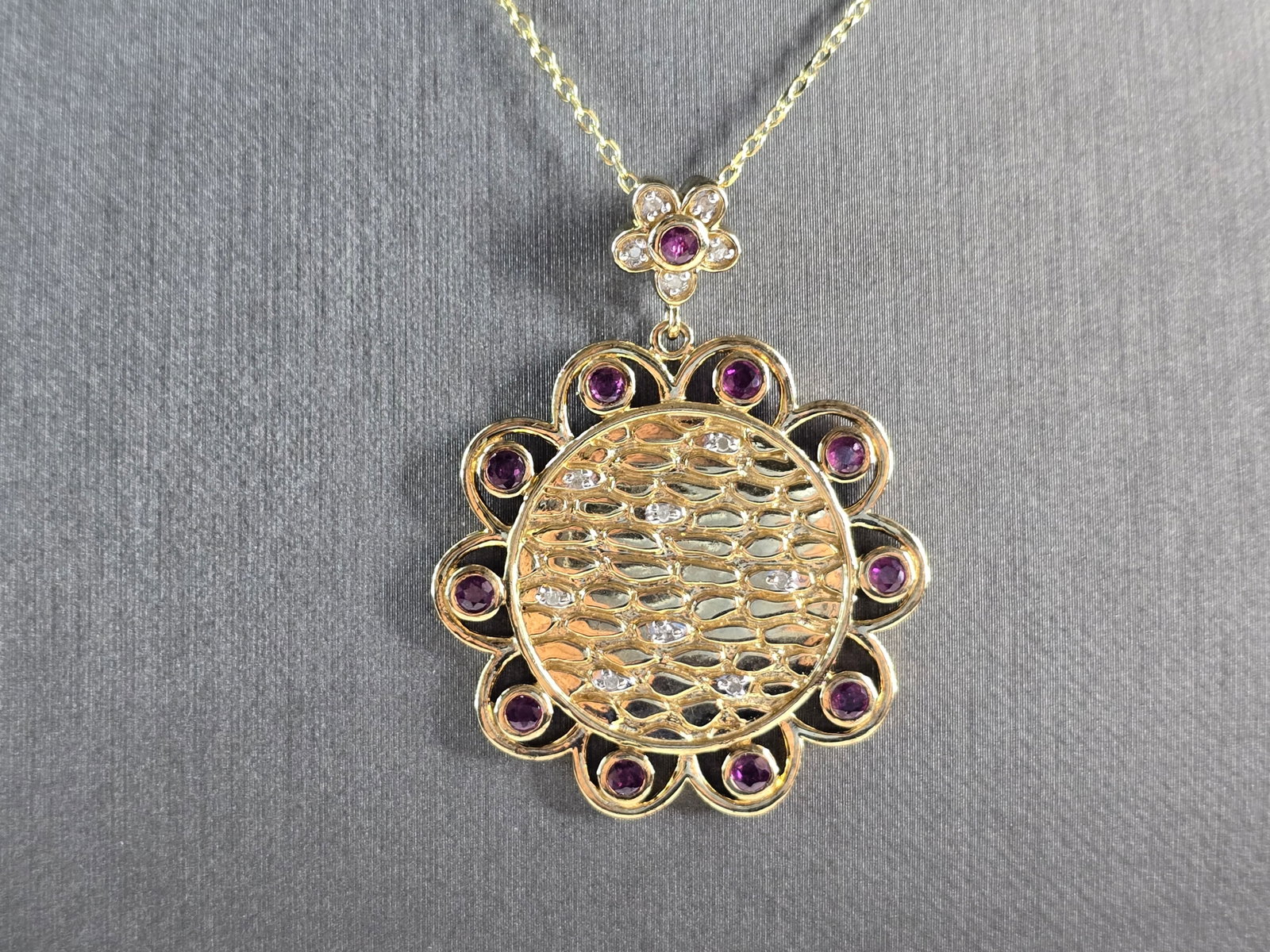 Womens Sterling Silver Gold Tone Amethyst Pendant Necklace: A WOMENS GOLD TONE STERLING SILVER AMETHYST PENDANT WITH NECKLACE. THE TOTAL WEIGHT IS 11.7g. PENDANT MEASURES 1 3/4" LONG BY 1 1/4" WIDE, AND NECKLACE IS 18" LONG. NOT SURE IF THE STONES ARE NATURAL 