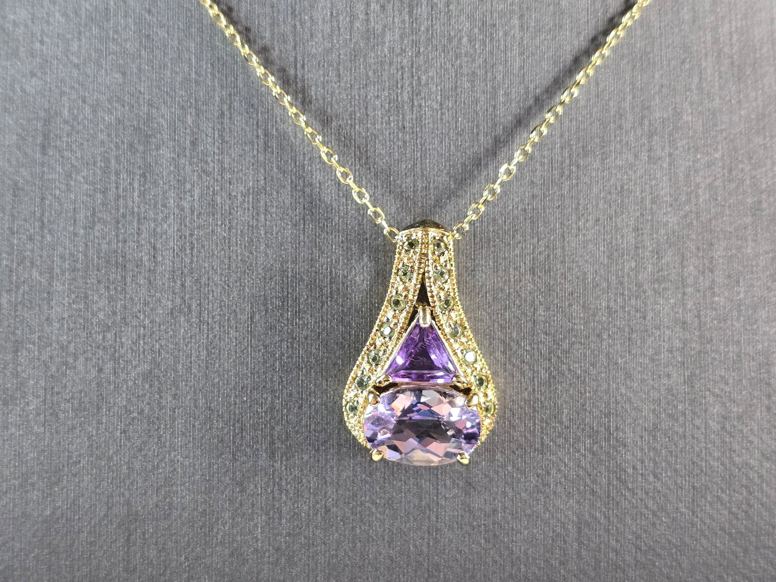 Womens Sterling Silver Gold Tone Amethyst Pendant Necklace: A WOMENS GOLD TONE STERLING SILVER AMETHYST PENDANT WITH NECKLACE. THE TOTAL WEIGHT IS 7.4g. PENDANT MEASURES 1" LONG BY 3/8" WIDE, AND NECKLACE IS 17 3/4" LONG. NOT SURE IF THE STONES ARE NATURAL OR 