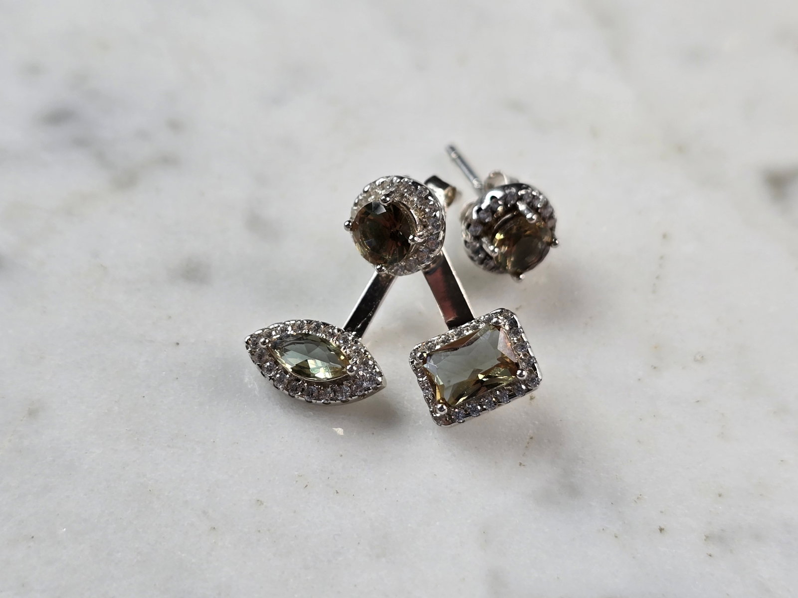 Womens Sterling Silver Modernist CZ Earrings: A PAIR OF WOMENS STERLING SILVER CZ MODERNIST EARRINGS THAT WEIGH 3.0g AND MEASURES 3/4" BY 5/8". THE SINGLE STUD MEASURES 1/4" WIDE. THE EARRING WITH THE THREE STONES CAN BE TAKEN APART AND YOU CAN J