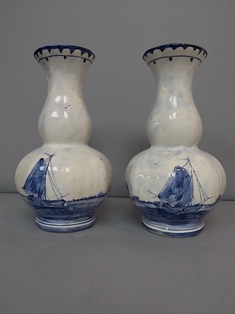 PR OF ANTIQUE DELFT BLUE HOLLAND HAND PAINTED VASES: A PAIR OF ANTIQUE DELFT BLUE VASES THAT ARE HAND PAINTED AND WERE MADE IN HOLLAND. AS YOU CAN SEE THEY HAVE A NICE SEASCAPE SCENE WITH A DUTCH WINDMILL IN THE BACKGROUND. THE VASES EACH MEASURE 10" TA
