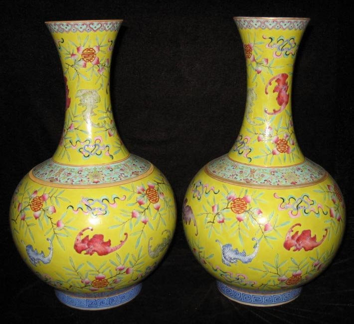 Pair Chinese famille rose bottle porcelain vases: Pair yellow ground Chinese famille rose bottle porcelain vases, Qing Guang Xu period (1875~1908), decorated with bats and peaches, height: 11 1/5".