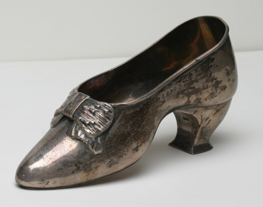 English Silver Ladies Shoe.: Marked G.N./R.H. for George Nathan & Ridley Hayes, with left facing lion, Chester city mark, & "N." Good condition with small dent in heel. 7 1/4" l., 4" h. Provenance: from the James & Judy (Jones) P