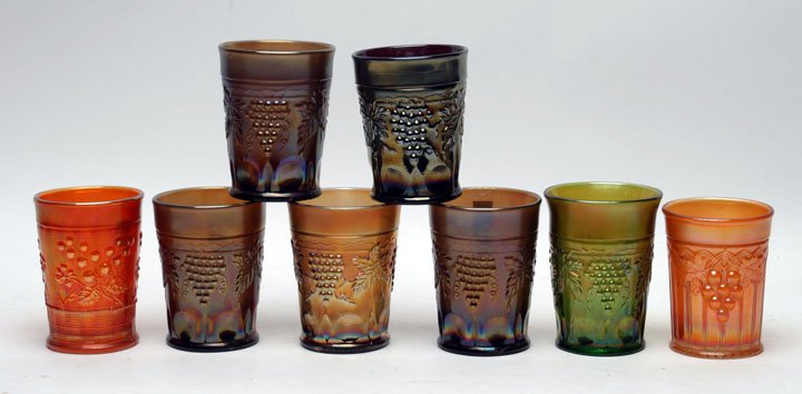 Northwood Carnival Glass Tumblers, Lot of Eight: Eight Northwood Tumblers consisting of one tankard size green Grape & Cable, five water size purple amethyst Grape & Cable, one marigold Grape & Gothic Arches & one marigold Raspberry. Northwood Glass