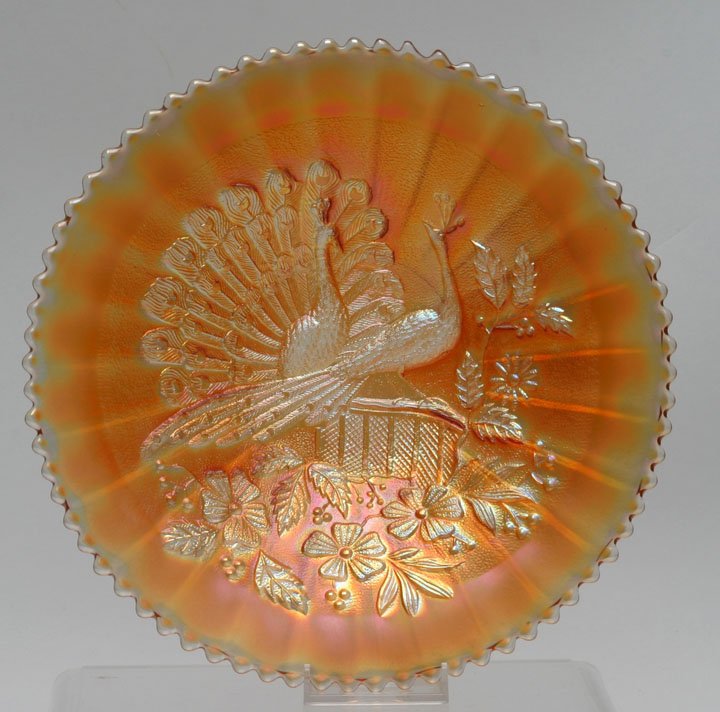 Northwood Peacocks on the Fence Stippled Plate: Northwood Carnival Glass Peacocks on the Fence Marigold Stippled Plate with good iridescence and ribbed exterior pattern. Northwood Glass Co. 9 1/8" D top, 1 1/2" H. Carolyn Price Collection, Bridgewa