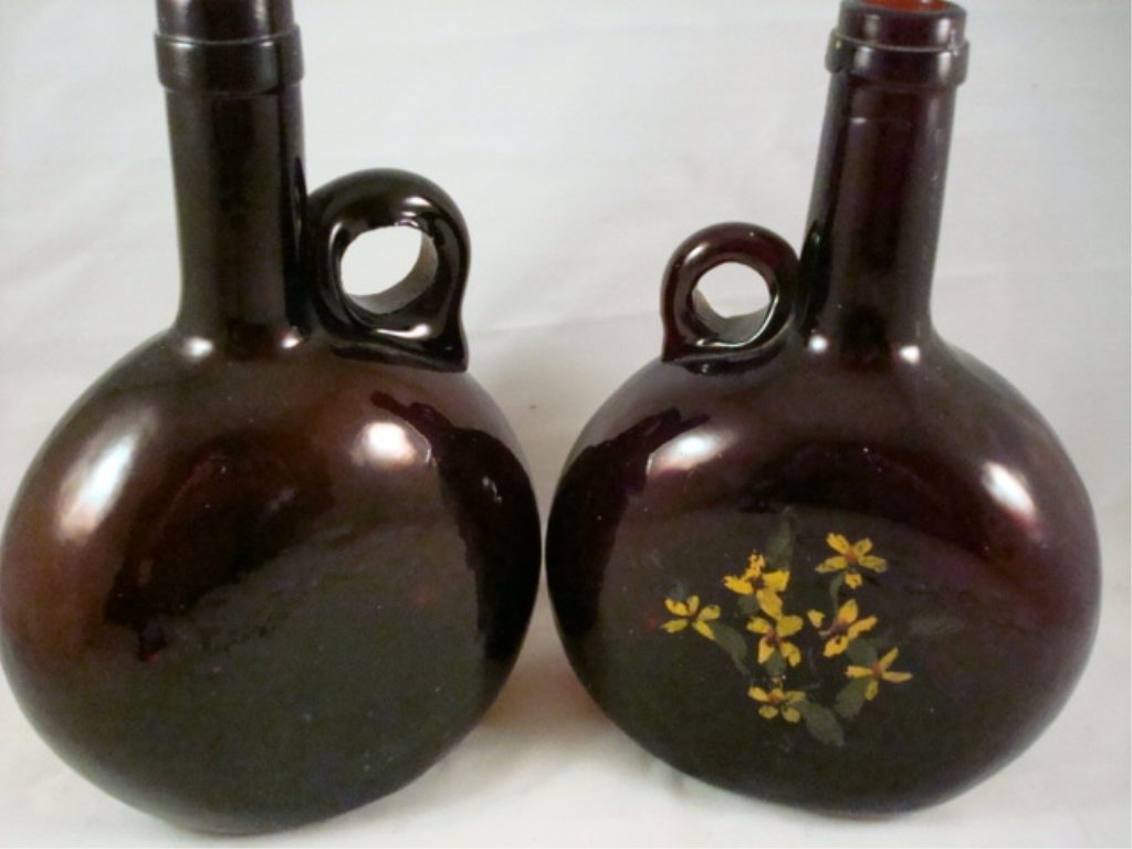 (2) Handled Chestnut Bottles 8" x 5": (2) Handled Chestnut Bottles 8" x 5" brown glass - no chips - one has painted flowers on front panel