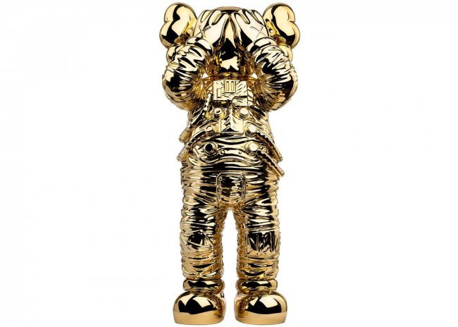 KAWS - HOLIDAY SPACE FIGURE - GOLD: The KAWS Holiday Space Figure is literally out of the world. Prior to the release of this coveted collectible, KAWS teamed up with All Rights Reserved to send this figure into space. The artist shared