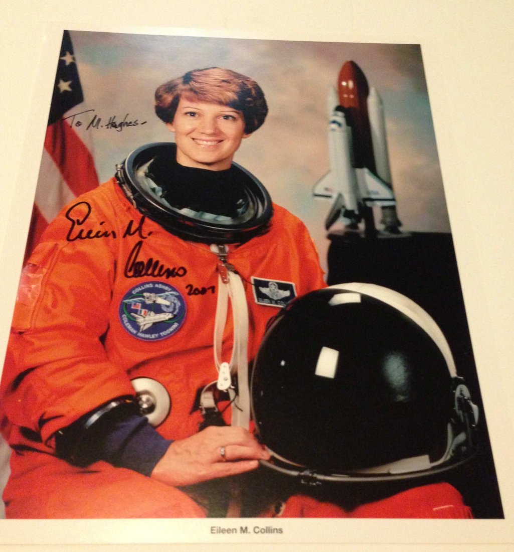 Autographed Photo of Astronaut Eileen Collins: This is a signed, 8x10 glossy color photo of female astronaut Eileen M. Collins. Ms. Collins is a retired U.S. Air Force Colonel, and was the first female Space Shuttle pilot in 1995, and later the fi