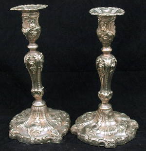 Candlesticks: Pair of Ornate Hand Beaten Hallmarked Sterling Silver Candlesticks, marks worn unable to date, plaster filled. No weight available due to plaster filling in base. Height 24cm, width 11cm, each.