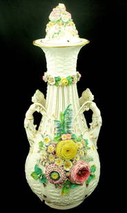 Porcelain Jar: 19th Century porcelain jar highly encrusted with cherubs & flowers - some damage all-over & cracking to base (65cm tall)