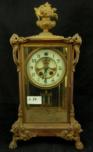 Mantel Clock: Late 19th Century brass framed fully glazed American mantel clock in the French manner having an exposed escarpment by the Gilbert Clock Co, USA - key & pendulum, mechanical condition unknown. (40cm)