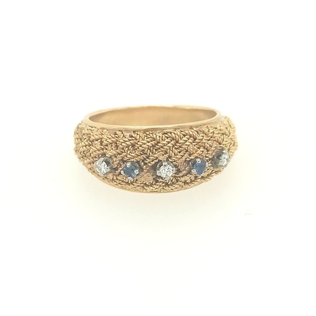 A Diamond & Sapphire Band: crafted in 18k yellow gold featuring (3) round diamonds weighing approximately .09cttw and (2) roun dsapphires weighing approxiamtely .07cttw Size: 5.75 ring size Weight: 3.8dwt