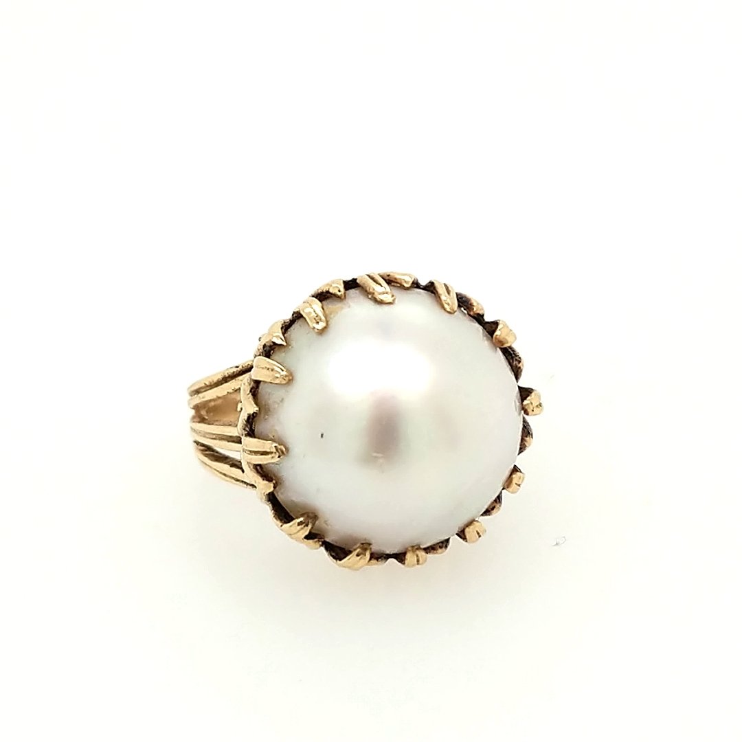 A Mabe Pearl Ring: Crafted in 14k yellow gold featuring (1) mabe pearl measuring approxiamtely 16.5 mm in diameter. Size: 5 ring size Weight: 6.0dwt