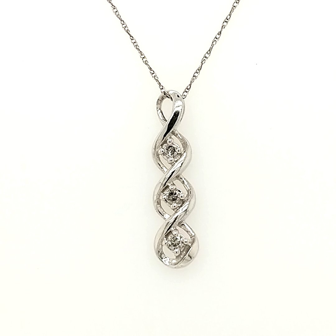 A Diamond Pendant: Crafted in 10K white gold featuring (3) round diamonds weighing .10cttw. The pendant is 1" long Size: The chain is 20" in length Weight: 1.0dwt