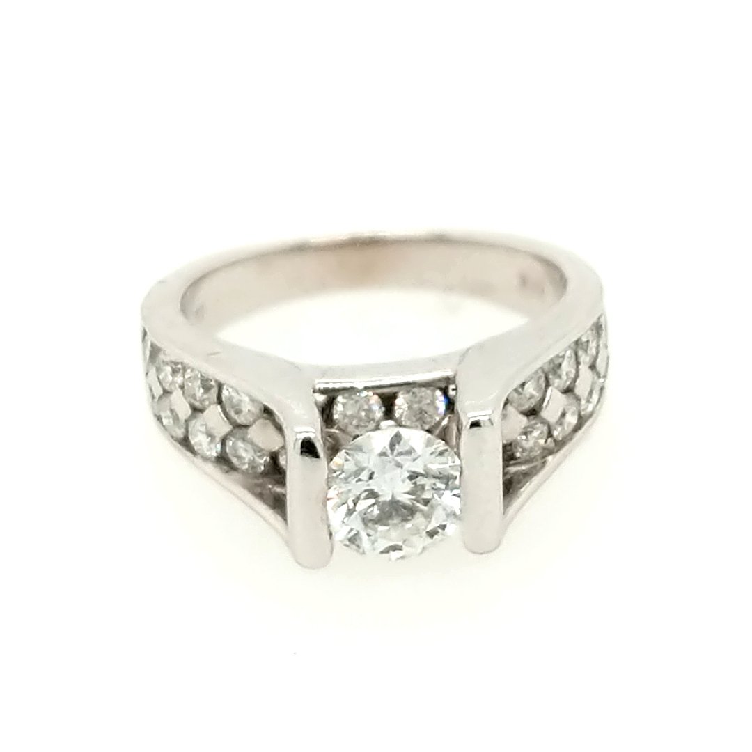 A Diamond Ring: Crafted in 14k white gold featuring (1) center round diamond weighing.65ct with a color of E/F and a clarity of SI3. There are also (24) round diamonds weighing approximately .75cttw. Size: 5 ring siz
