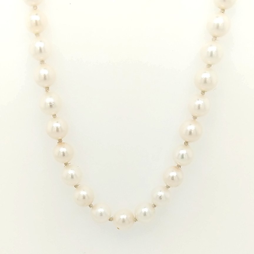 A Pearl Necklace: The clasp is 14k yellow gold with 6.3mm japenese akoya pearls. Size: 24" in length