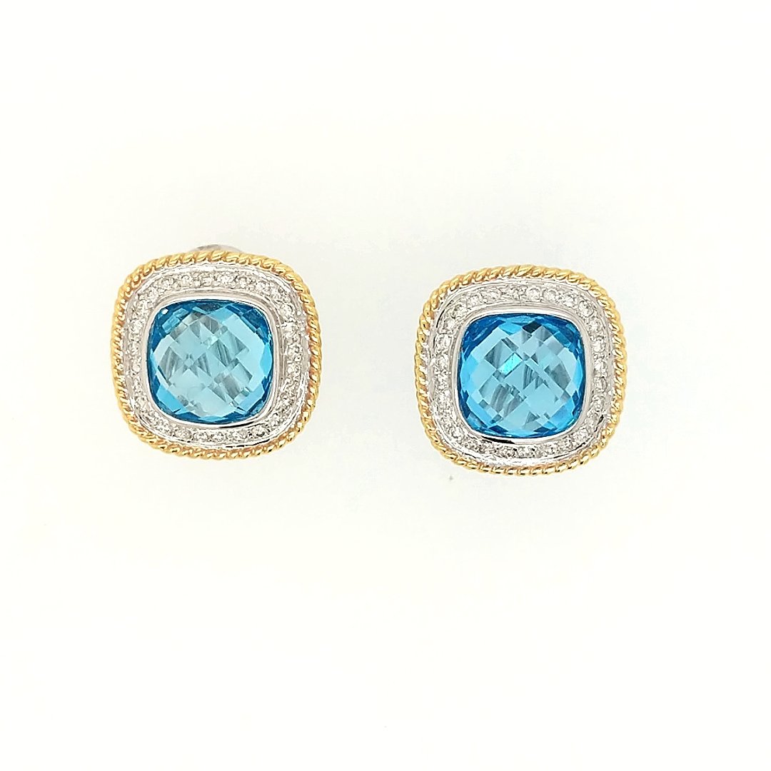 A Pair of Blue Topaz & Diamond earrings: Crafted in 18k white and yellow gold featuring (2) Cushion shaped blue topaz weighing 8.50cttw and (56) round diamonds weighing .55cttw. Size: the earrings measure 3/4" x 3/4" Weight: 6.8dwt