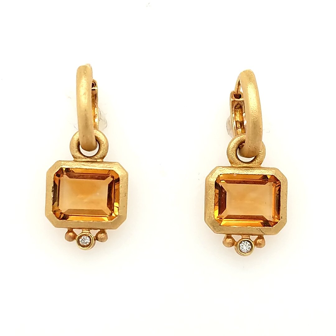 A Pair of Citrine & Diamond Earrings: Crafted in 14k yellow gold featuring (2) emerald cut citrines weighing approxiamtely 7cttw with (2) round diamonds weighing .06cttw. Size: 1" from top to bottom Weight: 4.5dwt