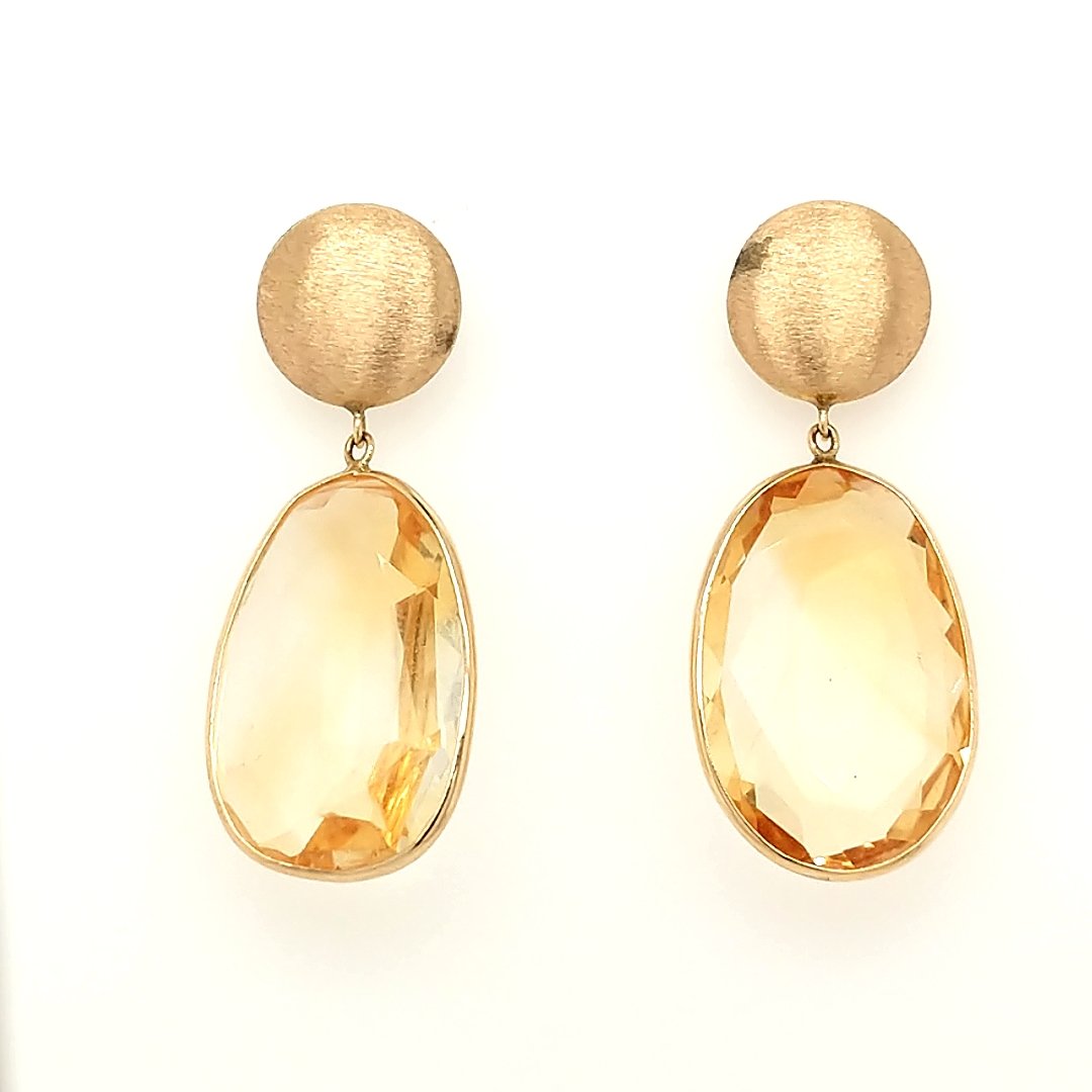 A Pair of Citrine Earrings: Crafted in 14k yellow gold featuring (2) oval shaped Citrines measuring 1" x 1/2" . Size: 1.5" from top to bottom Weight: 4.0dwt