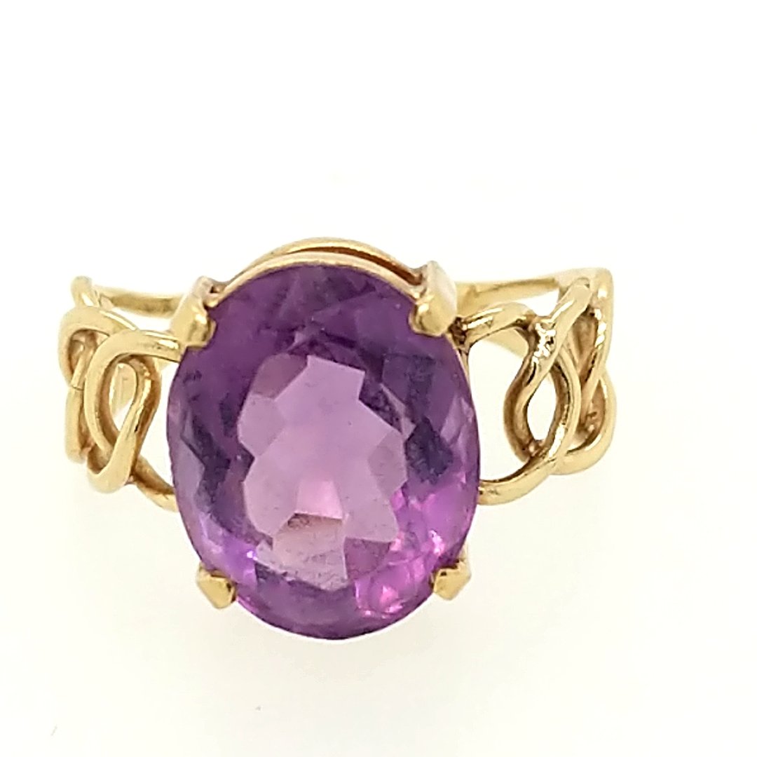An amethyst Ring: Crafted in 14k yellow gold featuring (1) oval amethyst weighing approxiamtely 6.0ct. Size: 5.5 ring size Weight: 2.1dwt