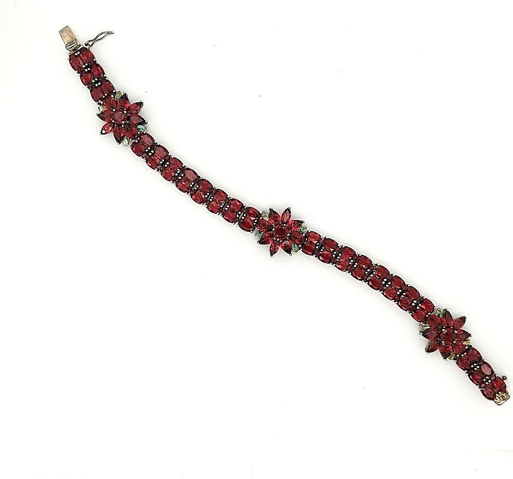 A Garnet Bracelet: Crafted in sterling silver featuring (71) garnets of various shapes weighing approximately 23.0cttw. Size: 7.25" in length Weight: 15.9dwt