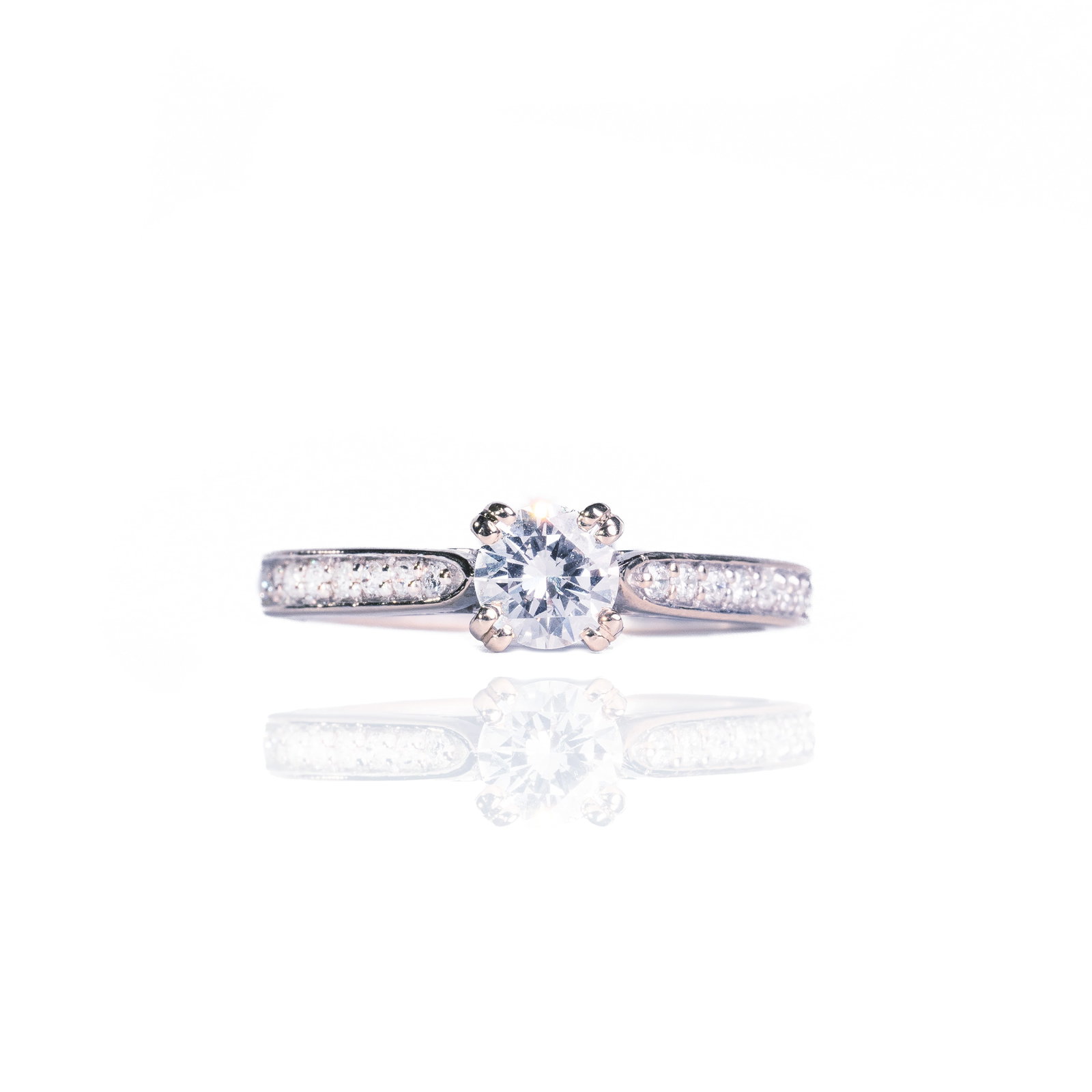 Diamond Ring: Crafted in 14k white gold featuring (1) round diamond weighing 0.54 ct with a color of E and a clarity of SI1. There are (16) round diamonds weighing 0.16 cttw. The ring is a size 6 1/2 and weighs 1.8