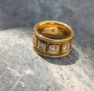 Elizabeth Gage Diamond Band: Crafted in 18k yellow gold featuring (10) round diamonds weighing approximately 1.0cttw. The ring measures 1/4in in width with a ring size of 6 1/4 and weighs 8.9 dwt. The ring comes with original Eli