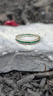 Tsavorite Eternity Band: Crafted in 14k white gold featuring (34) square step cut tsavorites weighing approximately 1.75cttw. The stones are channel set and the ring is a size 9 3/4 and weighs 1.5dwt