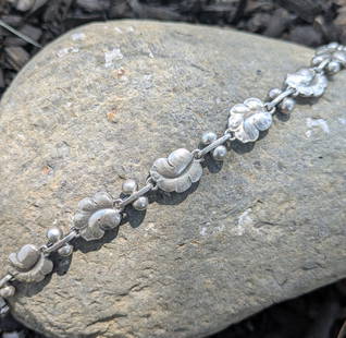 Vintage Georg Jensen Bracelet: This art nouveau grape leaf bracelet is crafted in sterling silver and signed Georg Jensen. The bracelet measures 7in in length and weighs 11dwt