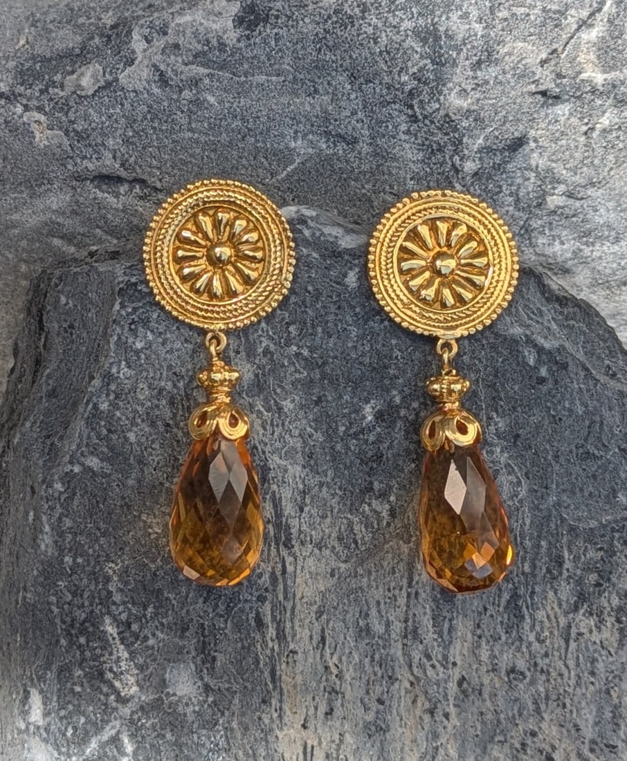Vintage Citrine Earrings: Crafted in 18k yellow gold featuring (2) briolette citrines. The earrings measure approximately 1 3/4in x 1/2in in width and weigh 7.9 dwt. Stamped TGD 18k