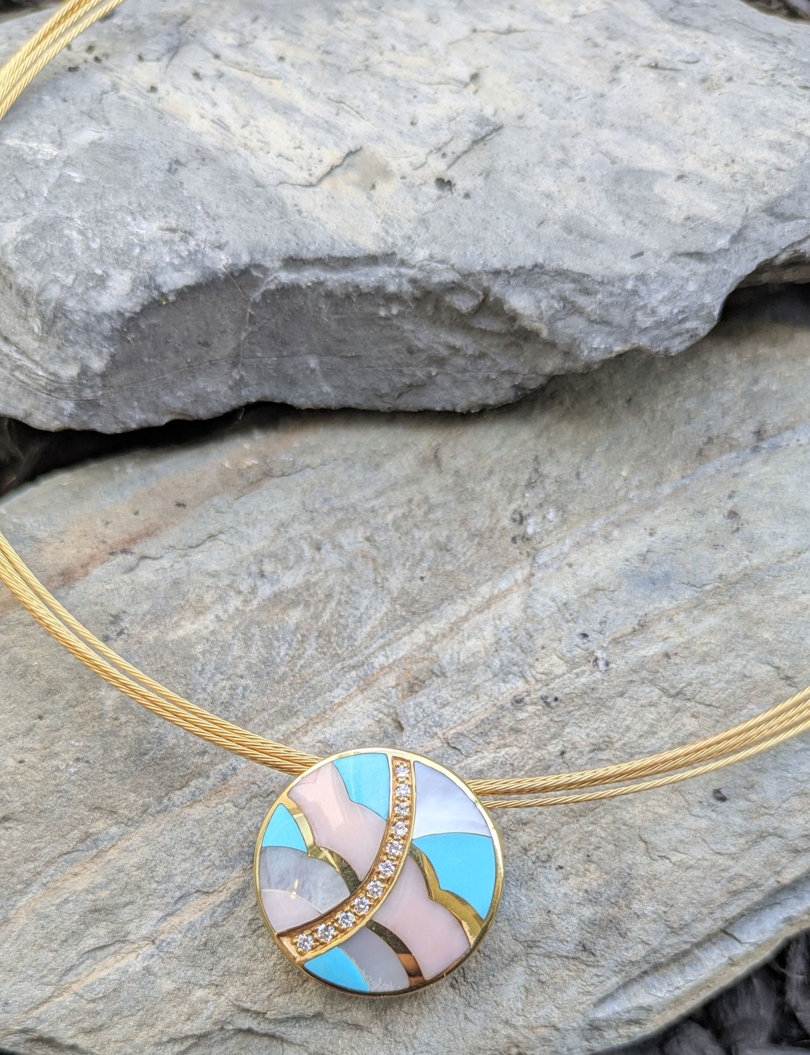 Asch Grossbardt Reversible Pendant and Necklace: Crafted in 14k yellow gold featuring a reversible pendant featuring diamonds, turquoise, coral and mother of pearl inlay. The reverse side features malachite, black onyx, mother of pearl and gold inla