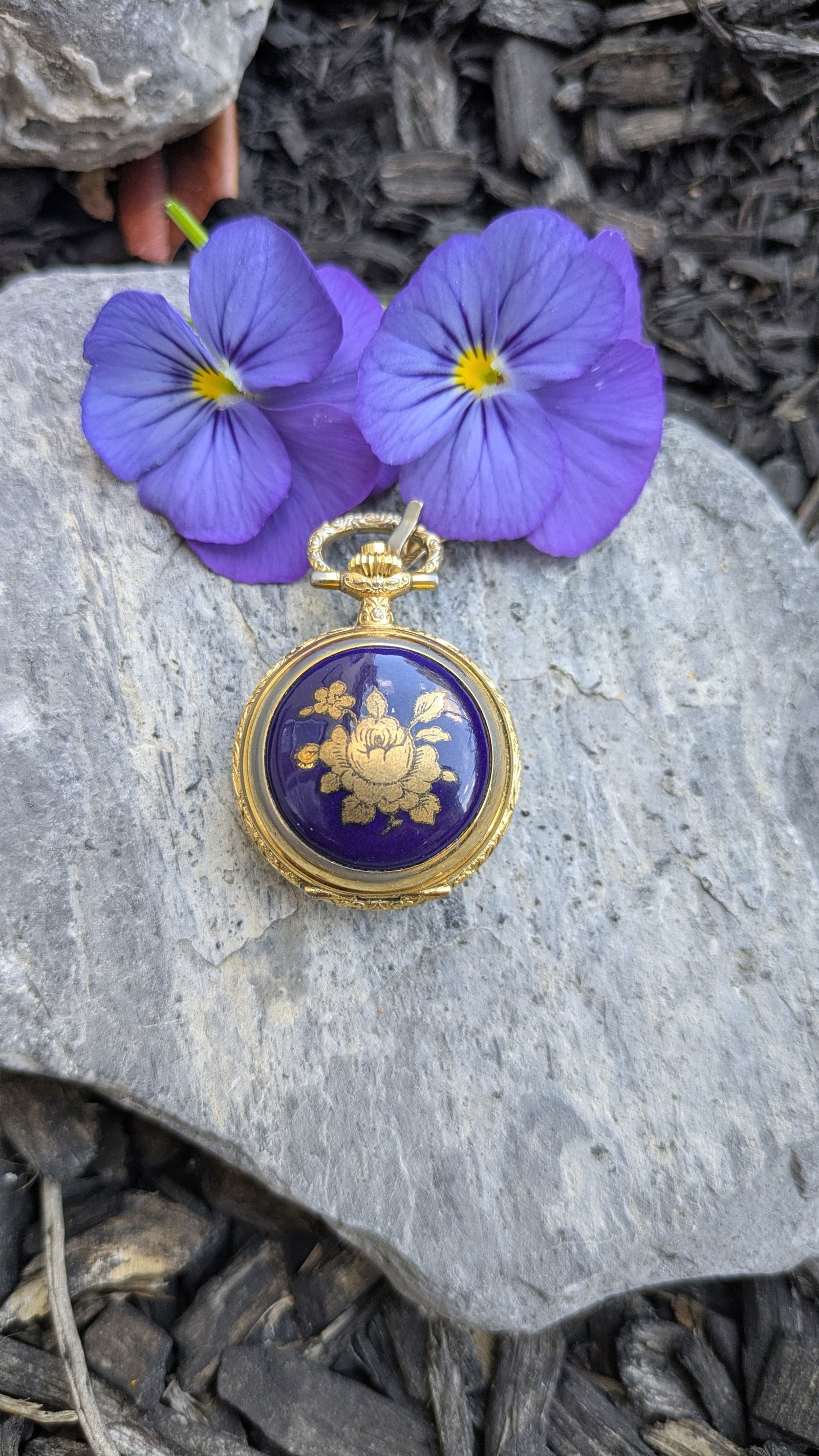 Vintage Aero Neuchatel Watch: This ladies pocket watch pendant is Swiss made and measures 1 1/2in x 1in. The watch features blue enamel and gold plate.