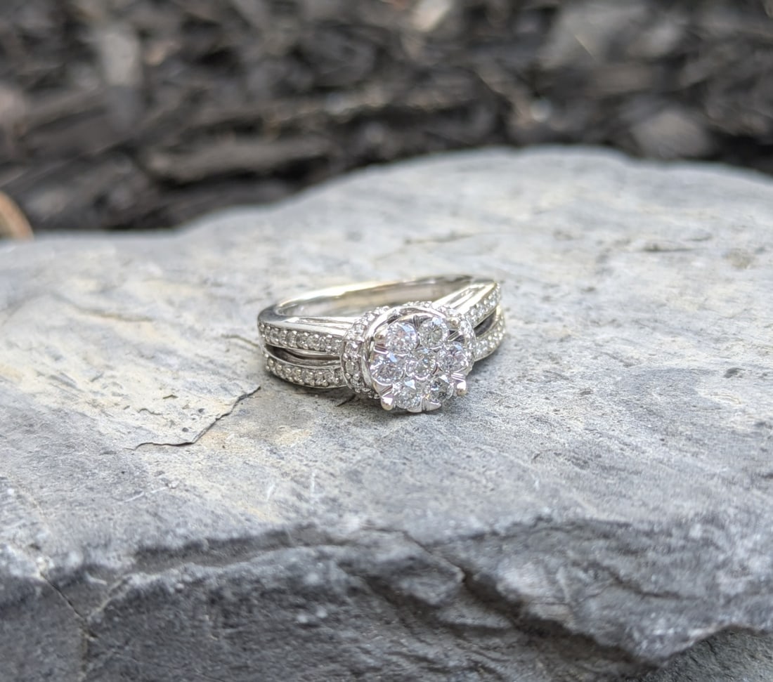 Diamond Cluster Ring: Crafted in 14k white gold, the ring features (7) round diamonds at the top weighing approximately .42cttw and (60) rounds diamonds weighing .60cttw for a total of approximately 1.0cttw. The ring is a